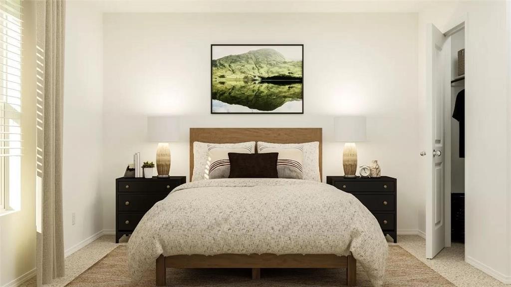 Neutral-toned room featuring light-colored wall-to-wall carpeting, horizontal window blinds, and a built-in closet with a hinged door Neutral-toned room featuring light-colored wall-to-wall carpeting, horizontal window blinds, and a built-in closet with a hinged door
