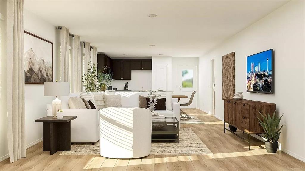 Open-concept interior featuring wood-finish flooring, recessed lighting, and large windows with full-length drapery Open-concept interior featuring wood-finish flooring, recessed lighting, and large windows with full-length drapery