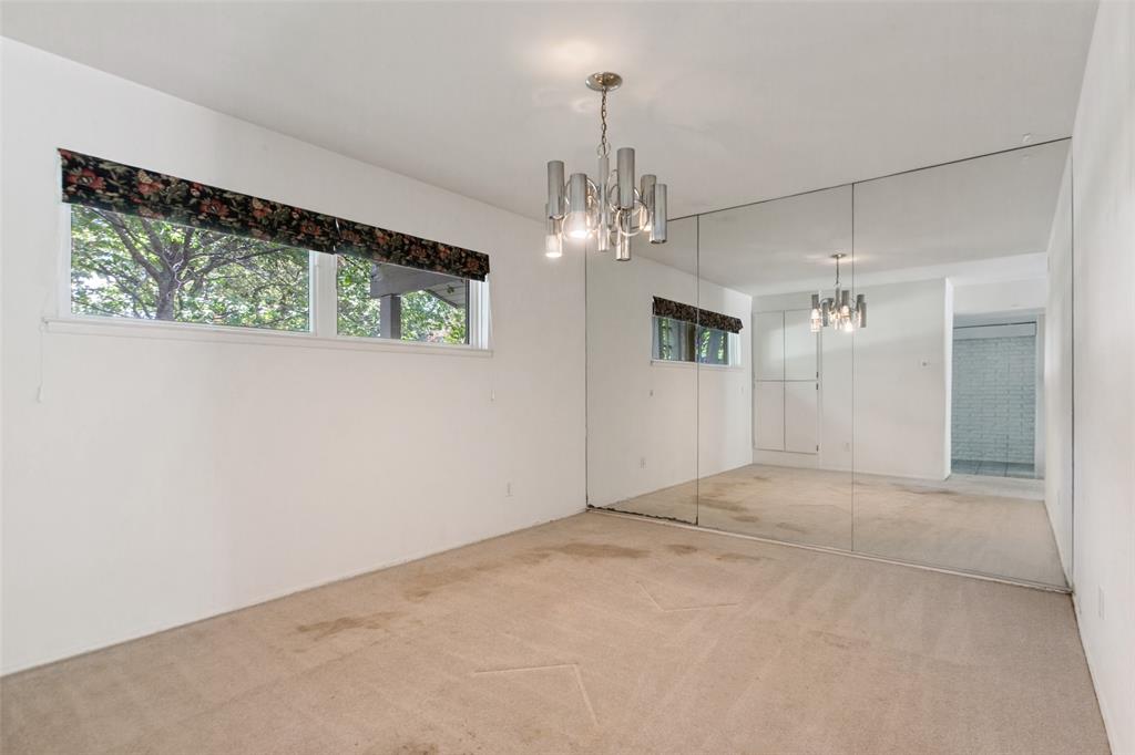 Dining area with mirrored wall off the foyer.