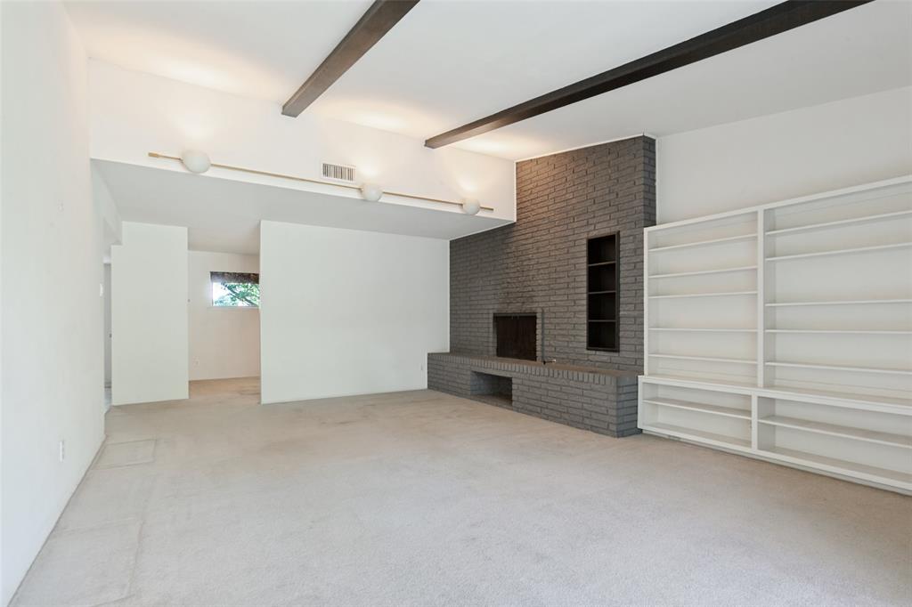 Living area with vaulted, beamed ceiling.