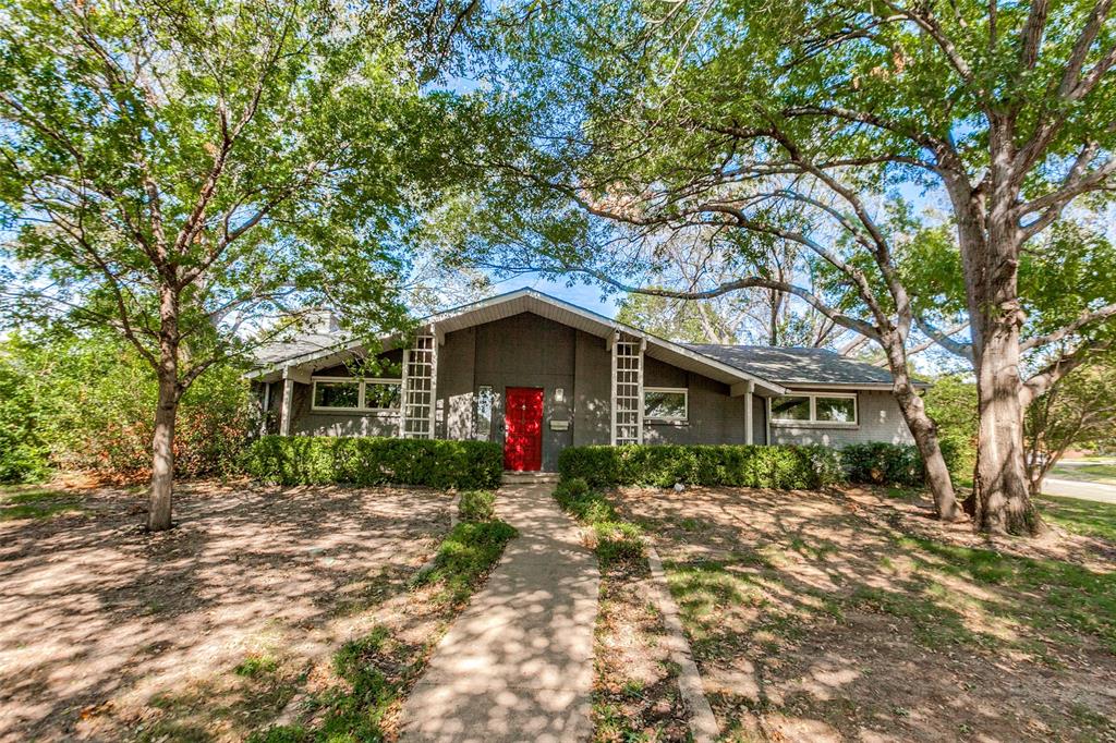 Mid-century-inspired architecture showcases clean lines, decorative exterior trellises, and a covered front patio.