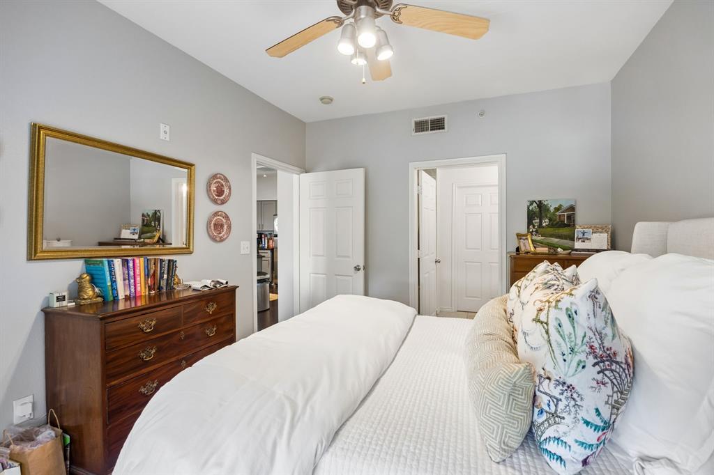 Neutral painted walls paired with a ceiling fan featuring light wood-finish blades and integrated lighting