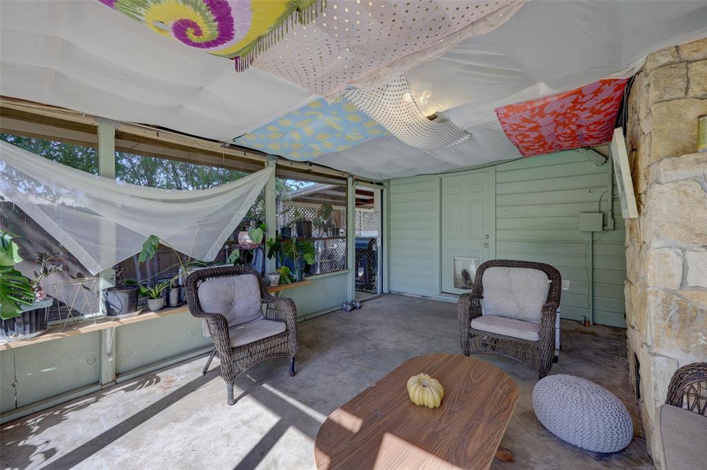 Large screened-in covered patio with retractable screen door to carport