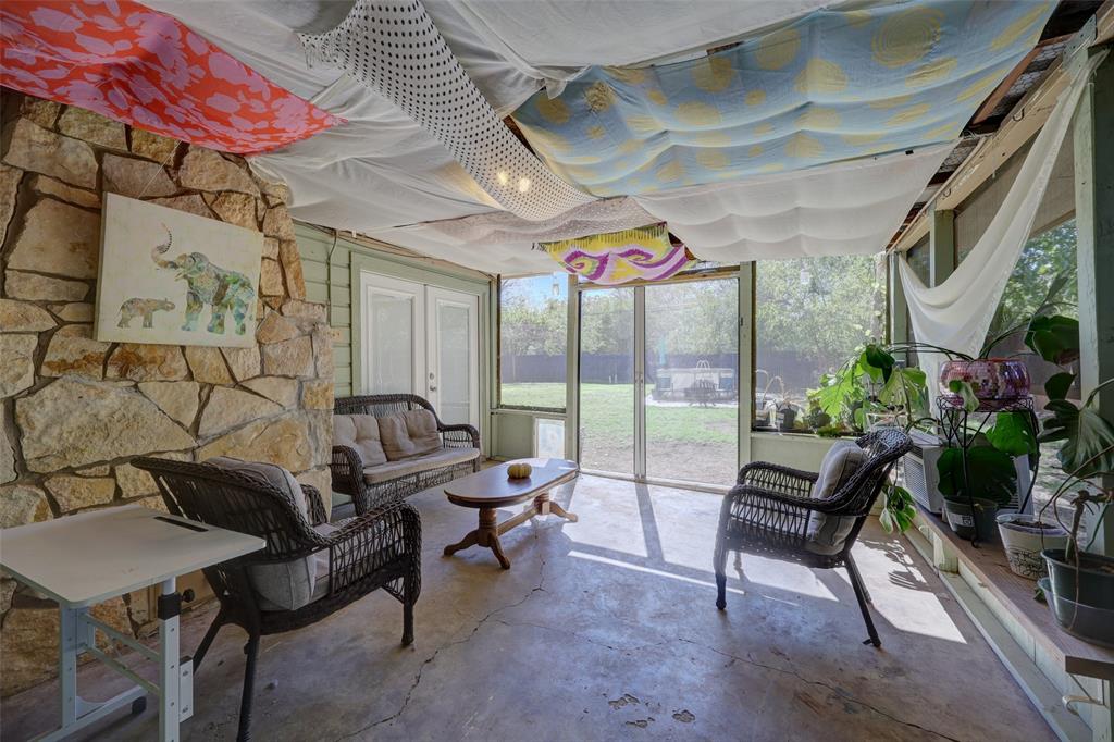 Back of stone fireplace adds character to the patio. Retractable screen doors to the  back yard