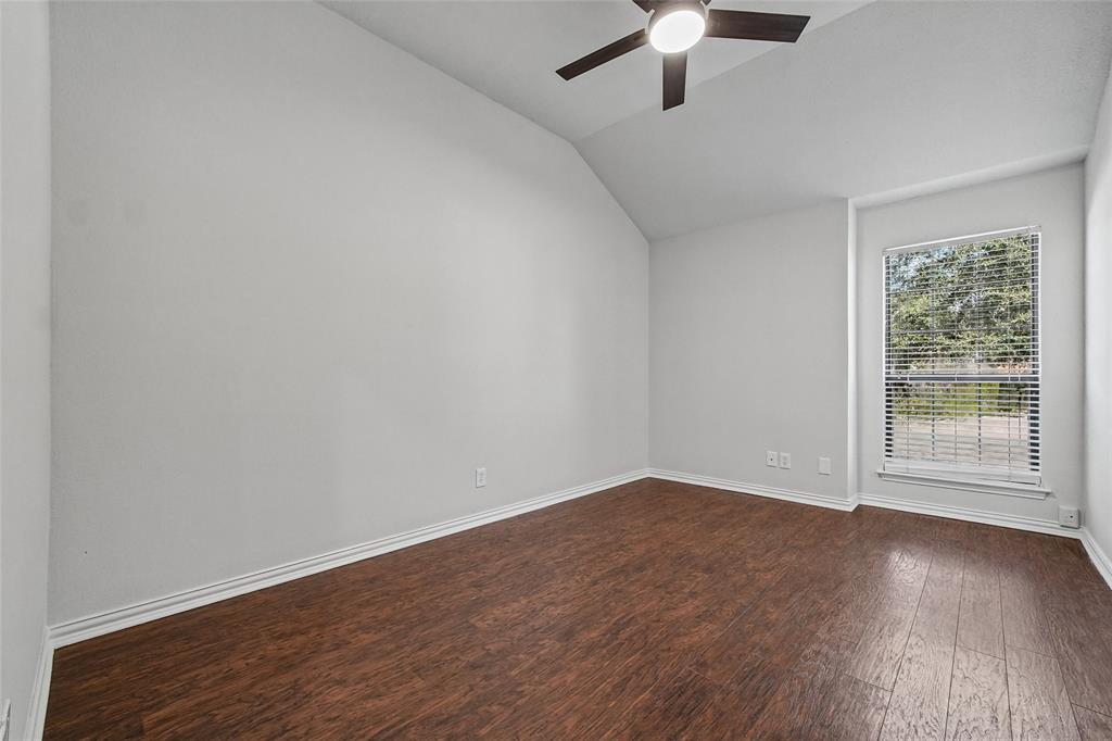 Vaulted ceilings, wood-finish flooring, and a ceiling fan with integrated lighting