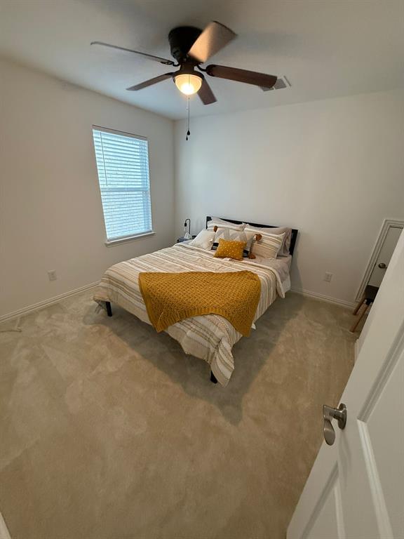 Bedroom featuring carpet and ceiling fan