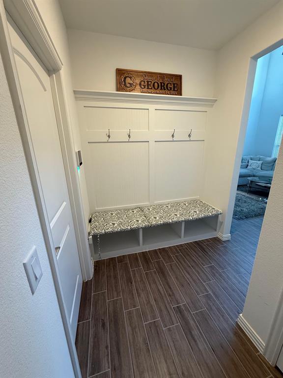 Mudroom featuring wood tiled floors and baseboards