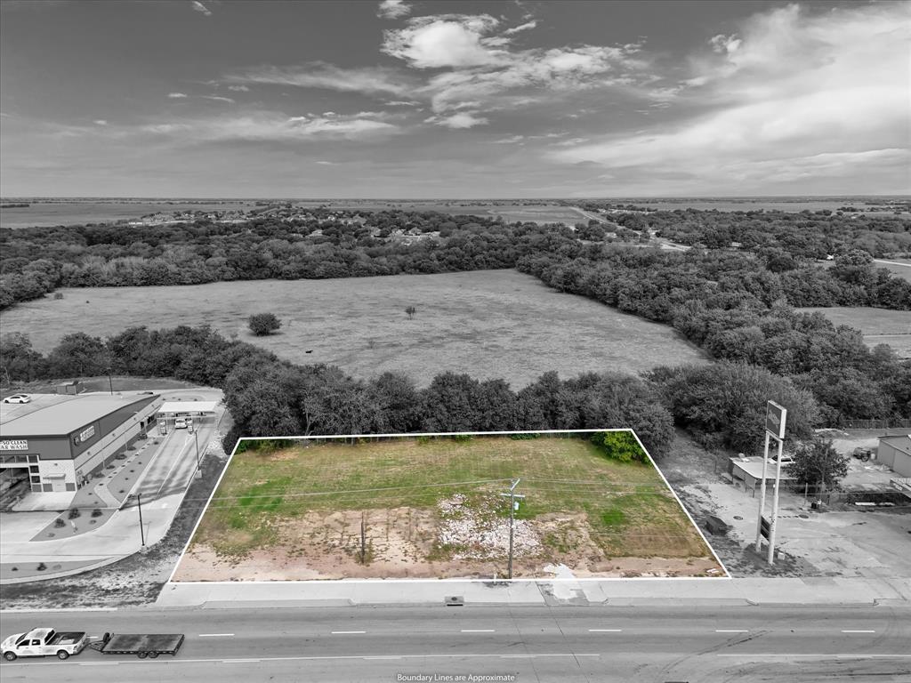 Vacant lot featuring direct street frontage, clear land area, and established perimeter vegetation