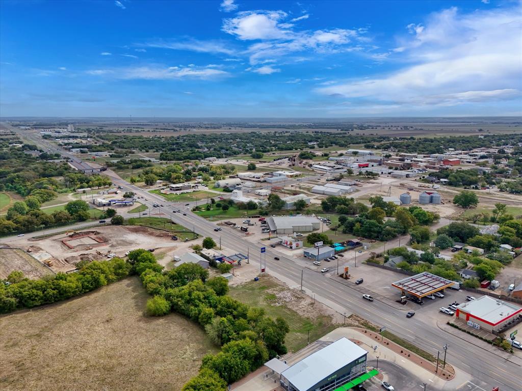 Aerial perspective featuring proximity to regional thoroughfares, local commercial infrastructure, and expansive acreage