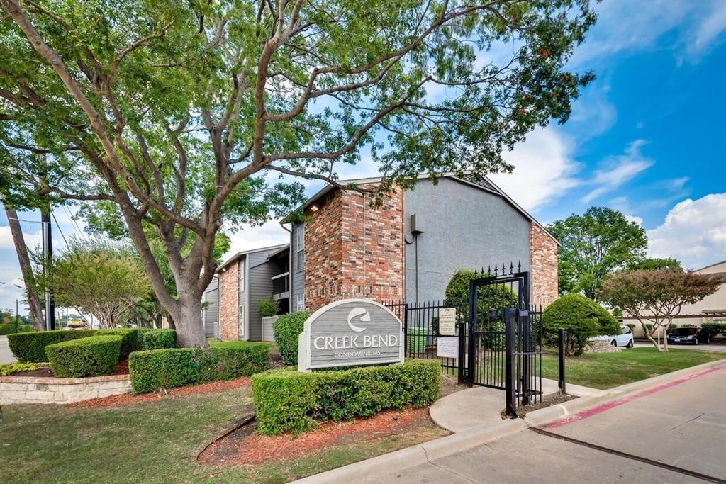 Exterior facade featuring a blend of brick and stucco masonry, mature landscaping, and gated entry Exterior facade featuring a blend of brick and stucco masonry, mature landscaping, and gated entry
