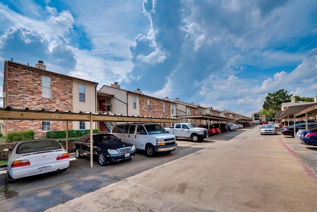 Exterior featuring brick and siding facade with metal-roofed carports Exterior featuring brick and siding facade with metal-roofed carports
