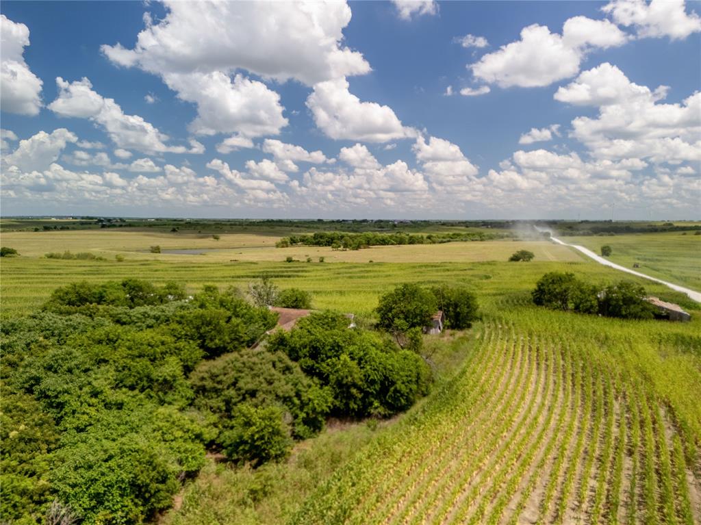 Aerial view of sparsely populated area with large plots for crops