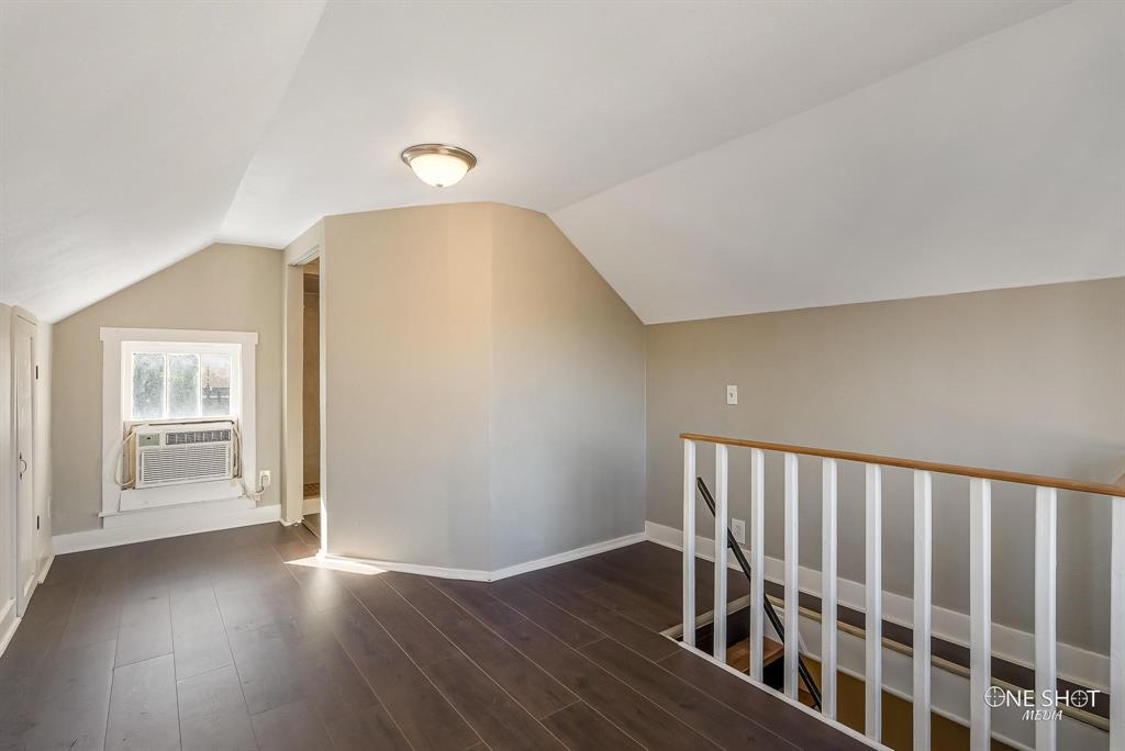 Bonus room with dark hardwood / wood-style floors, vaulted ceiling, and cooling unit