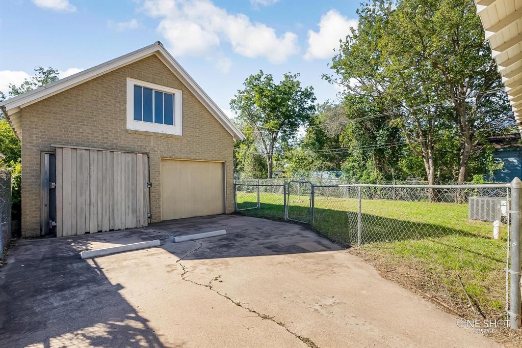 View of side of home featuring a yard