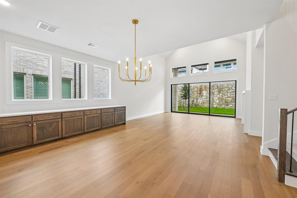 The spacious light filled dining room offers a row of cabinets creating the ideal serving space when hosting lively dinner parties or family get togethers. The spacious light filled dining room offers a row of cabinets creating the ideal serving space when hosting lively dinner parties or family get togethers.