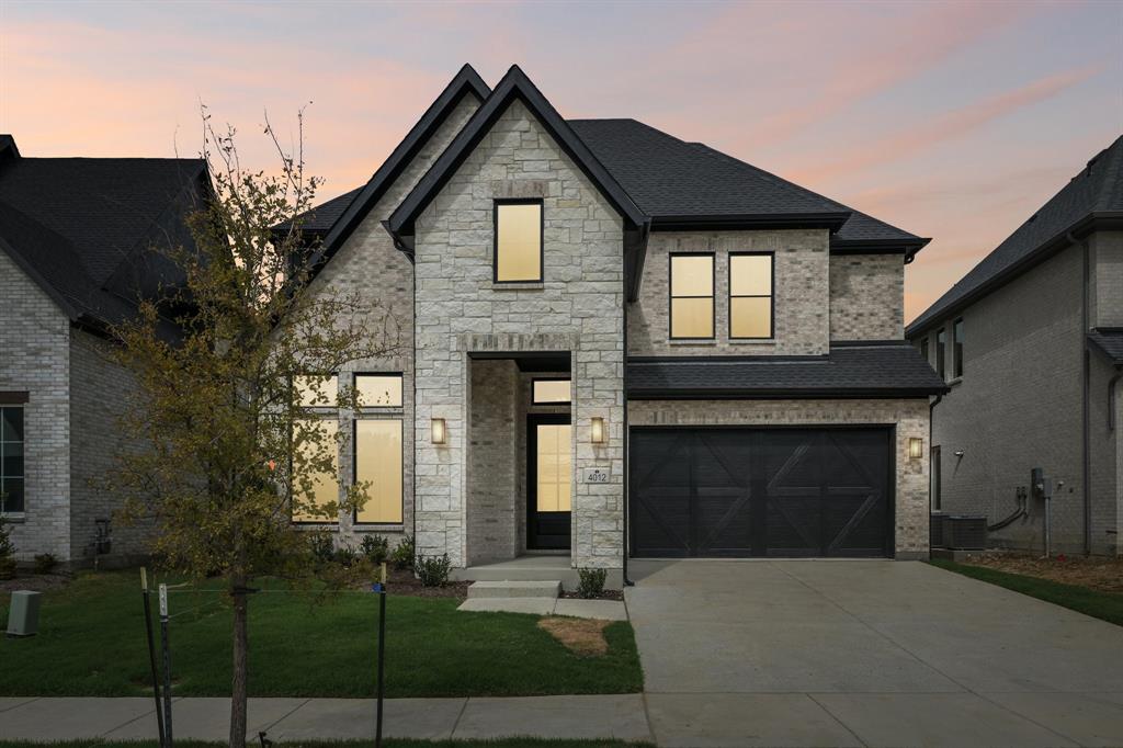 A dramatic stone entry paired with beautiful light colored brick and dark trim create outstanding curb appeal for this dream home! A dramatic stone entry paired with beautiful light colored brick and dark trim create outstanding curb appeal for this dream home!