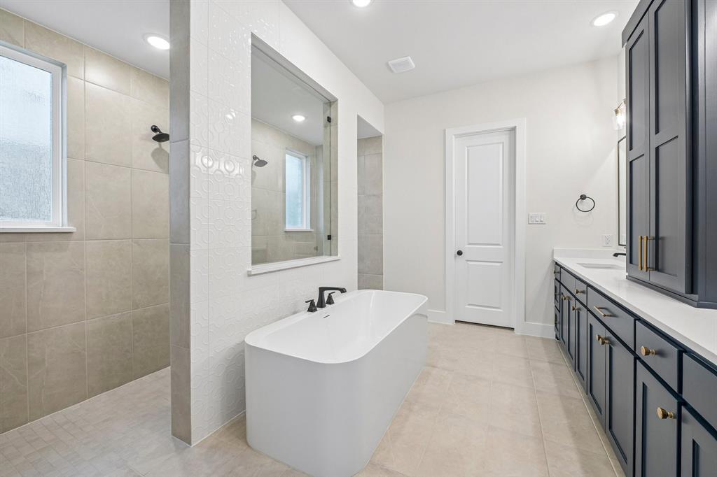 You'll enjoy a spa like experience every day in our signature owner's bath featuring a double walk through shower with free standing tub.