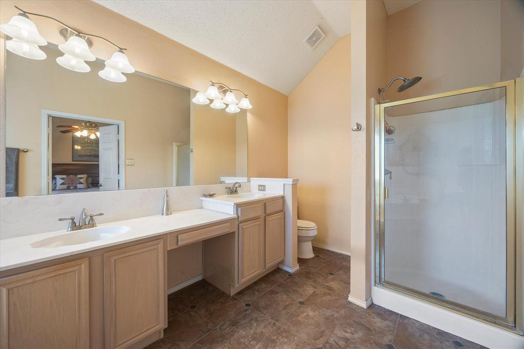 Master bath includes his and her vanities with makeup area
