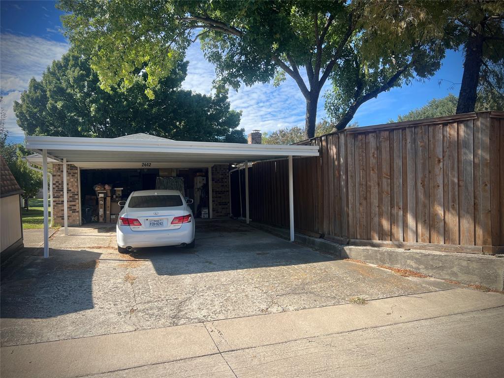 Carport behind the garage has two spaces, and provides extra covered parking.
