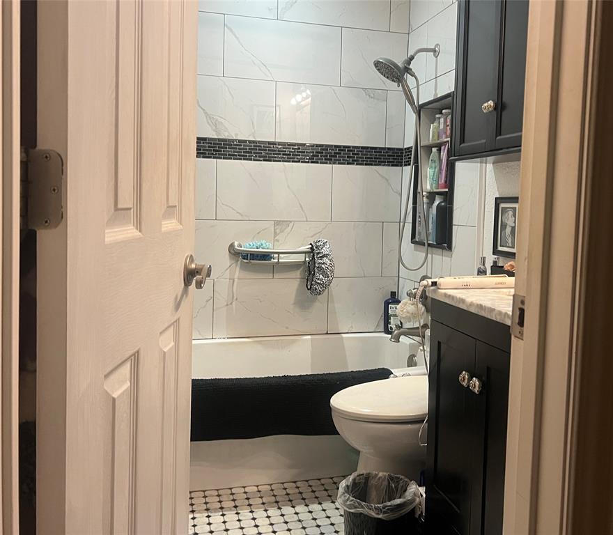 Hall bathroom, full bath, tub, shower and vanity.