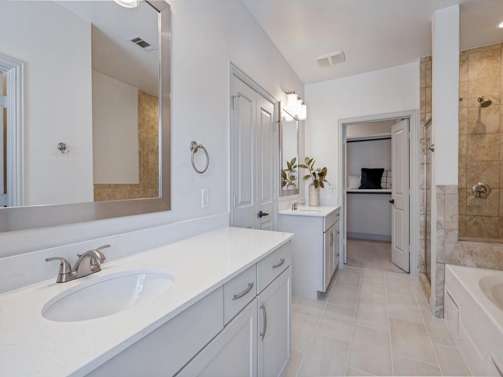 Primary bath with dual sinks & vanities. Walk-in closet.
