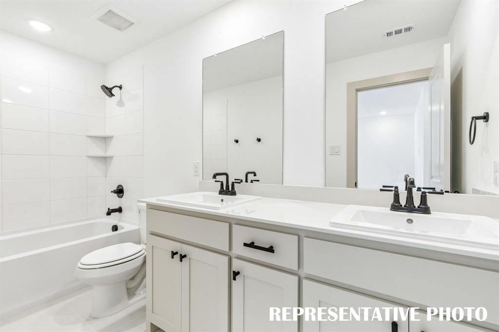 Guests will enjoy their own vanity space in this thoughtfully designed guest bath.  REPRESENTATIVE PHOTO