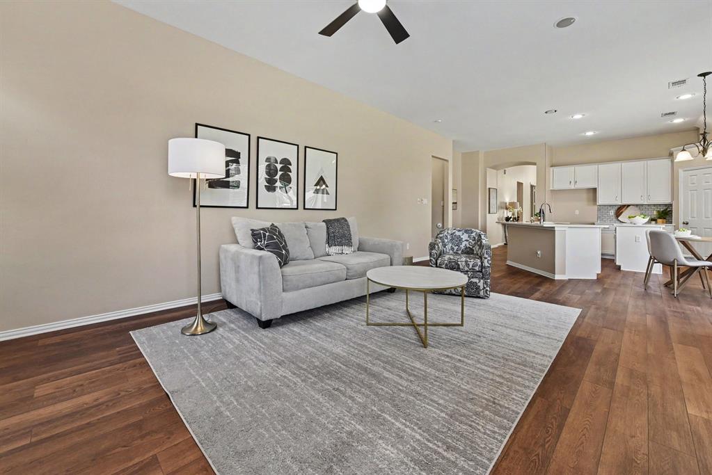Spacious den with ceiling fan open to kitchen