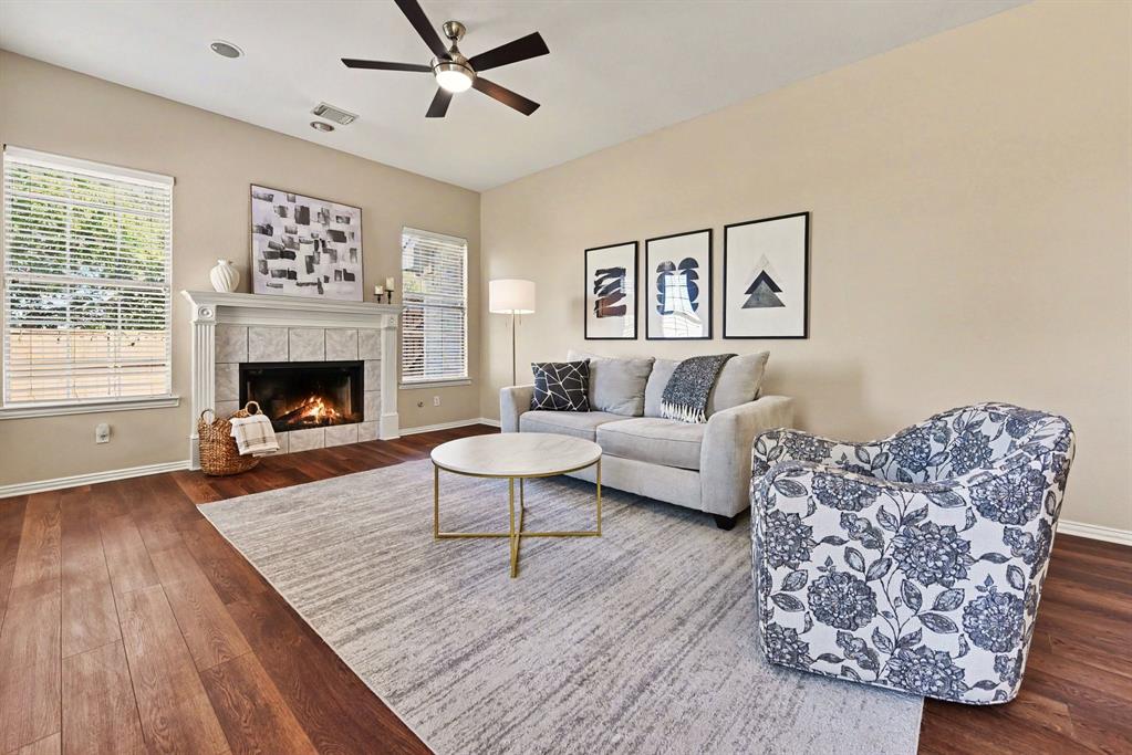 Den with fireplace and ceiling fan