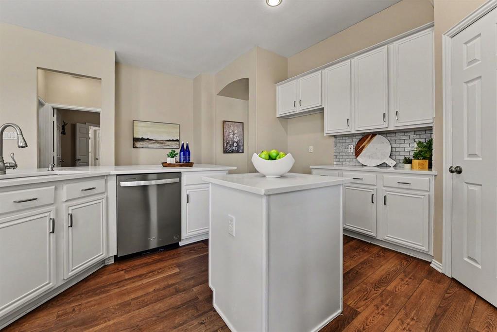 Kitchen with island and breakfast bar, stainless dishwasher
