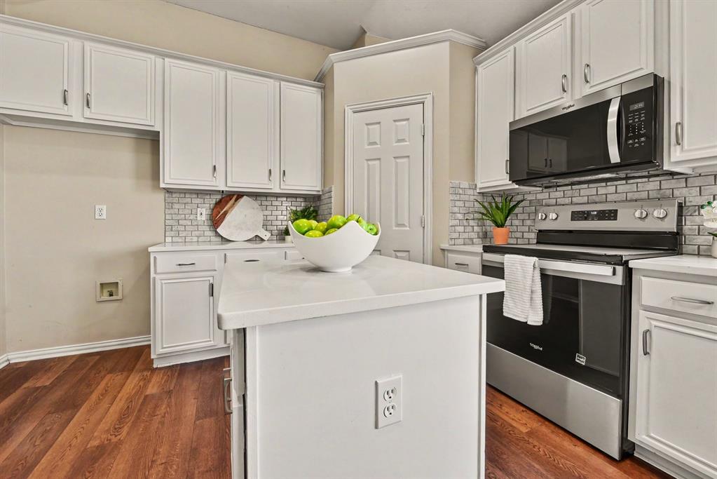 Kitchen with walk-in pantry, stainless range and microwave