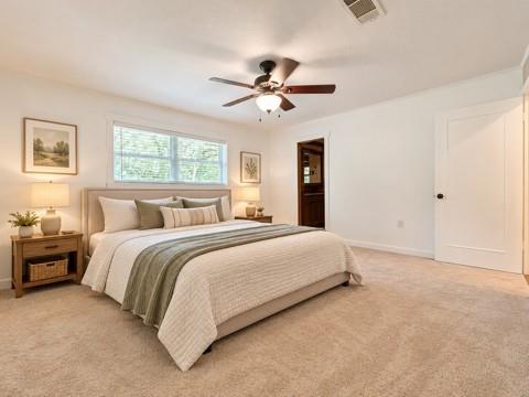 Neutral wall-to-wall carpeting, ceiling fan with integrated lighting, multi-pane window, and classic solid-core doors Neutral wall-to-wall carpeting, ceiling fan with integrated lighting, multi-pane window, and classic solid-core doors