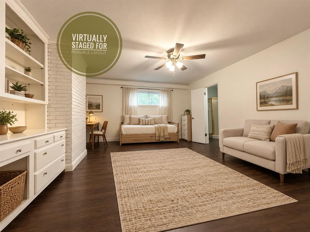 Cozy studio apartment with room for a bed and couch. Door leading to full bathroom. VIRTUALLY STAGED