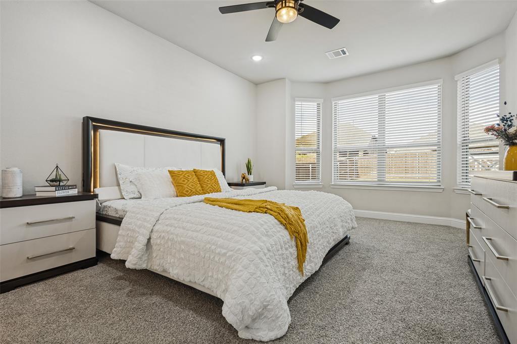 Room featuring a bay window, wall-to-wall carpeting, recessed lighting, and a ceiling fan