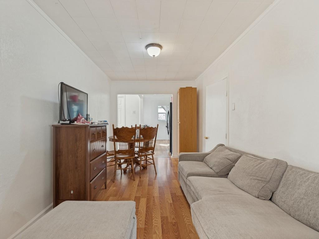 Wood-finish flooring, white walls, and a ceiling-mounted light fixture