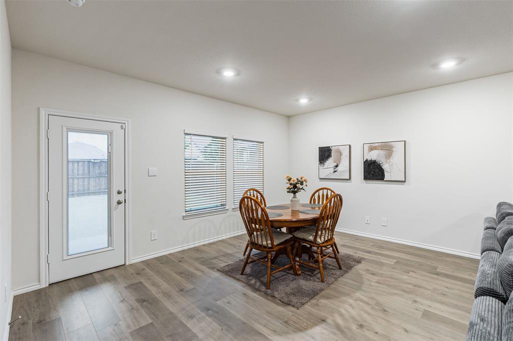 Neutral interior featuring wood-finish flooring, recessed lighting, and a glass-paneled exterior door