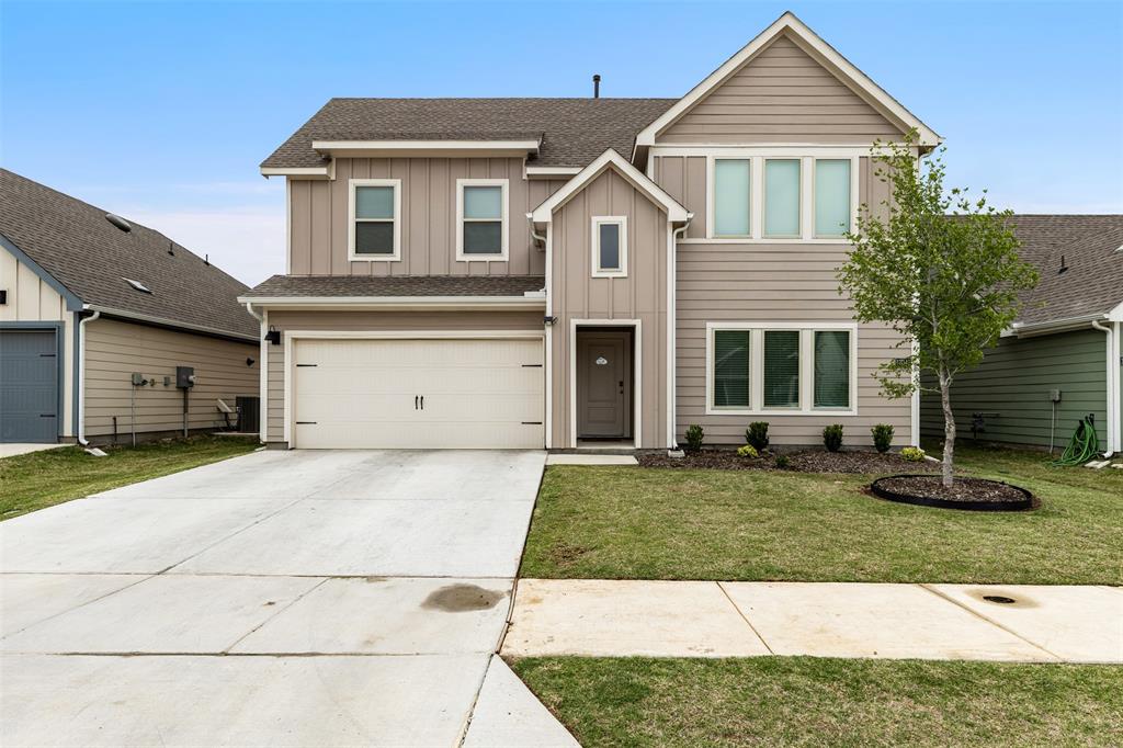Two-story residence featuring horizontal lap and vertical board-and-batten siding, a gabled roofline, an attached two-car garage, and a concrete driveway