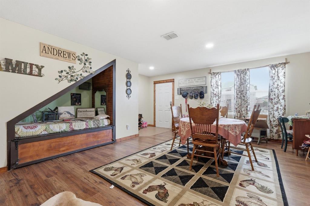 Built-in wooden alcove with angled frame, wood-finish flooring, recessed lighting, and large windows