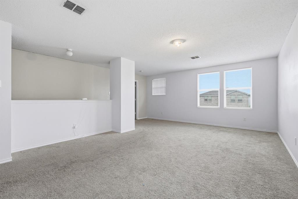 Open-concept interior featuring neutral wall tones, wall-to-wall carpeting, and double-paned windows