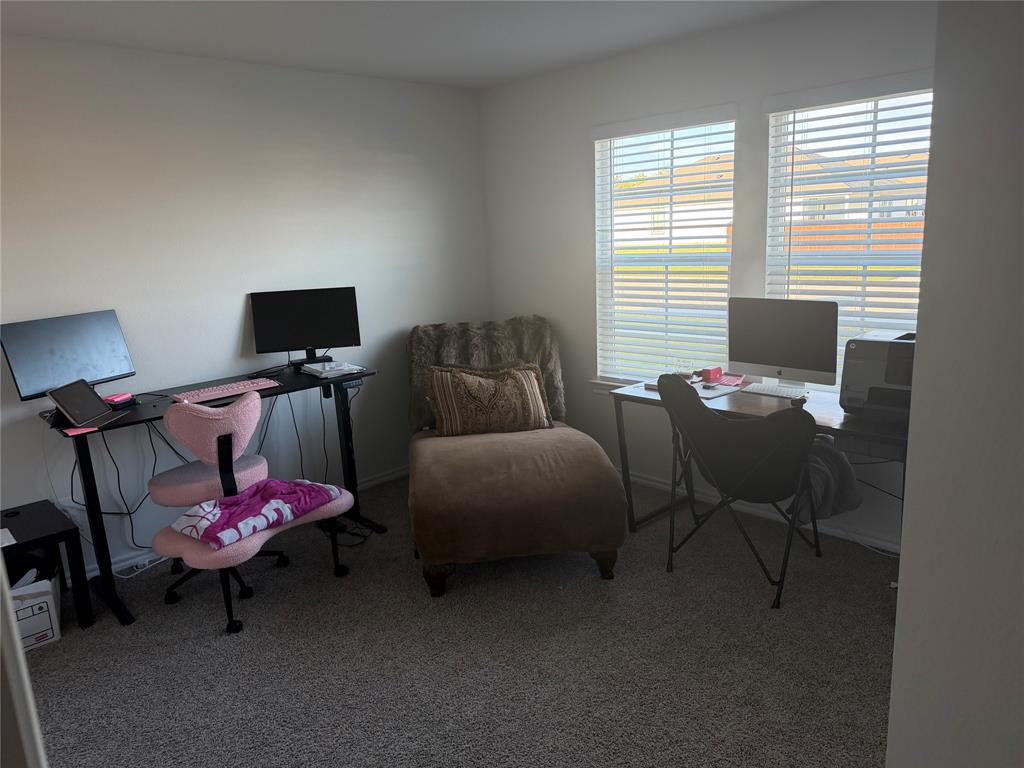 Neutral-toned room featuring neutral carpeting and two windows with horizontal blinds Neutral-toned room featuring neutral carpeting and two windows with horizontal blinds