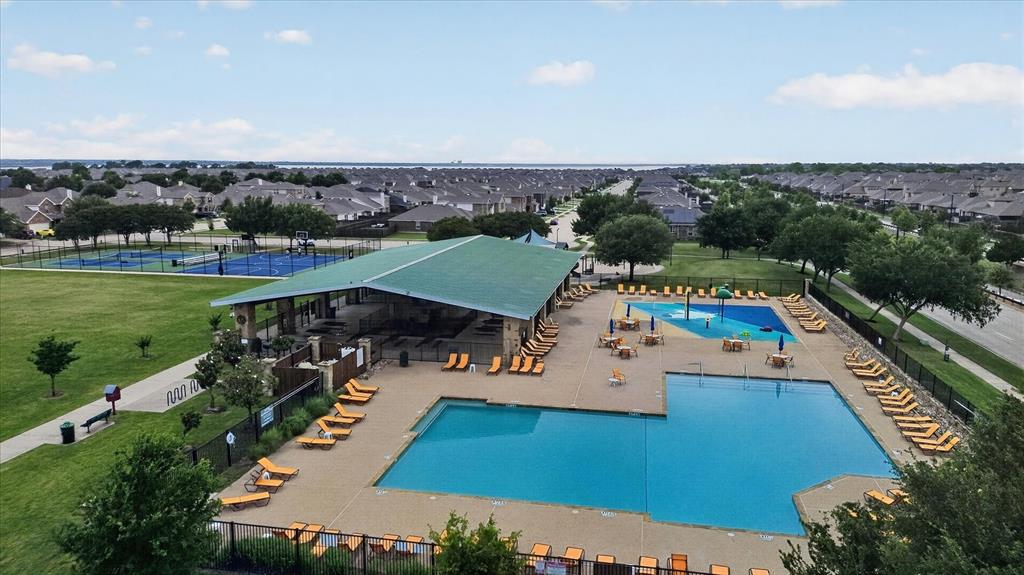 Community recreational center featuring a swimming pool, splash pad, covered pavilion, and sport courts