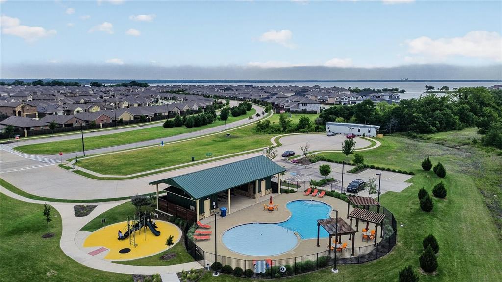 Community recreation area featuring a swimming pool, shaded pavilion, pergola, and playground