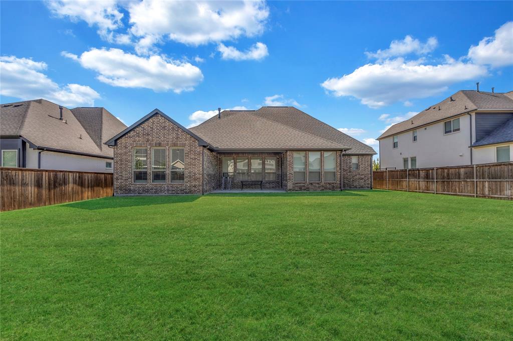 Full brick exterior, expansive fenced backyard, and a composition shingle roof