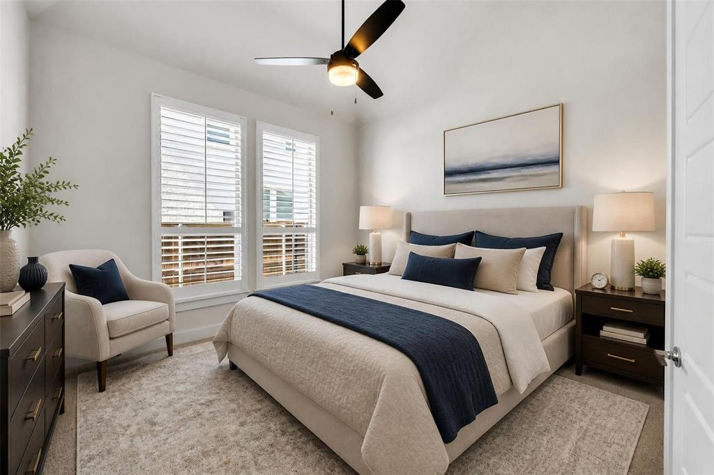 Neutral-toned room featuring two windows with integrated white shutters and a multi-blade ceiling fan with an integrated light fixture