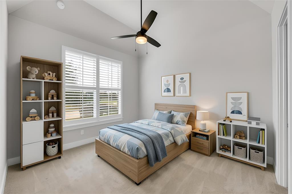 Vaulted ceilings, neutral carpeting, large windows featuring white plantation shutters, and a central ceiling fan with integrated lighting