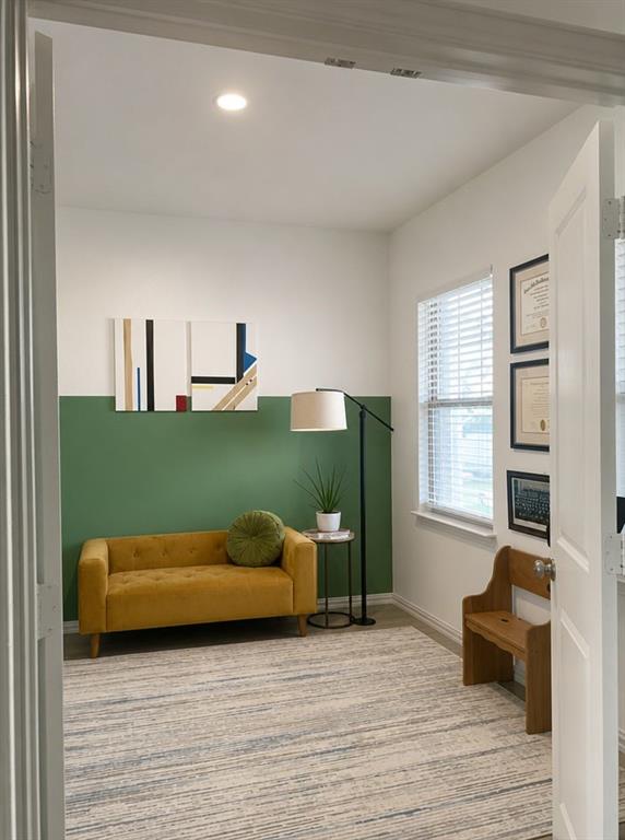 Interior room featuring wood-finish flooring, two-tone wall paint, recessed lighting, and horizontal window blinds Interior room featuring wood-finish flooring, two-tone wall paint, recessed lighting, and horizontal window blinds