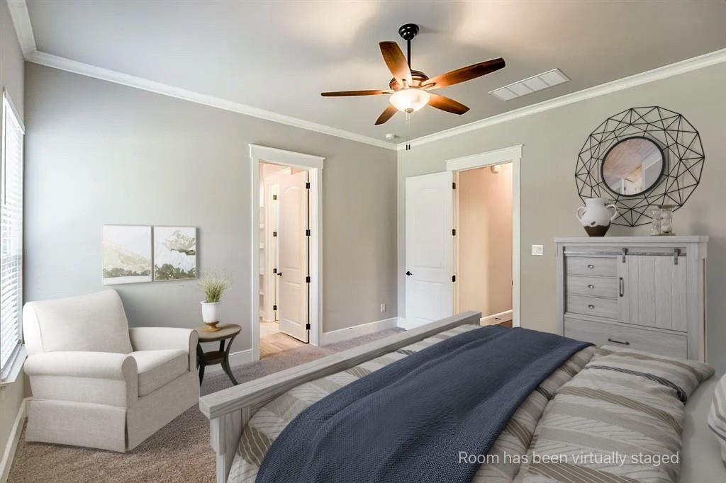 Neutral-toned walls featuring crown molding, carpeting, and a central ceiling fan with integrated light fixture