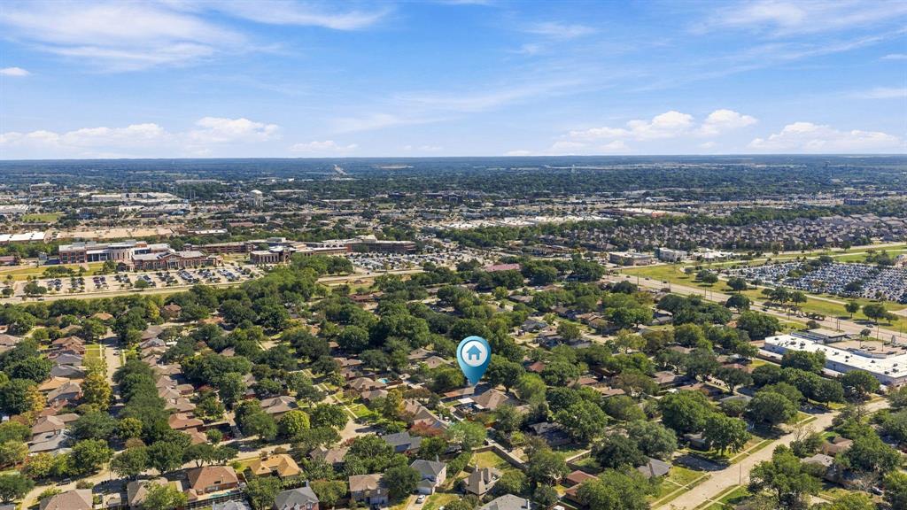 Aerial perspective of the residential property situated within a mature, tree-lined neighborhood