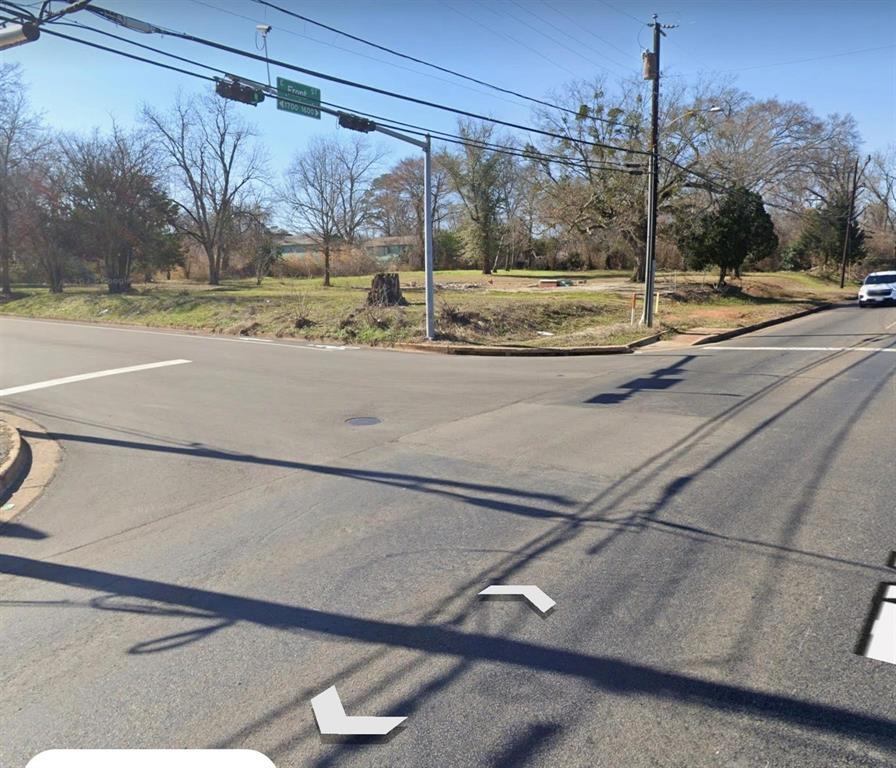 Corner lot featuring open green space and mature trees