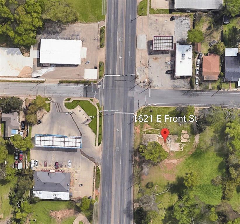 Aerial perspective featuring a corner lot with established trees and direct street access