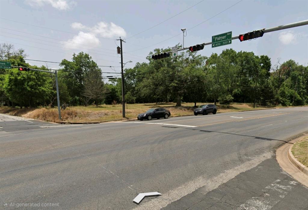 Vacant corner lot featuring mature tree clusters and direct access to street infrastructure